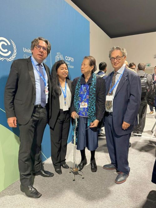 A group photo at COP29 featuring Cecile Alvarez, Dewy Sacayan, Viktor Sebek, and another delegate, standing in front of a COP29 banner, symbolizing their collaborative efforts in climate discussions.