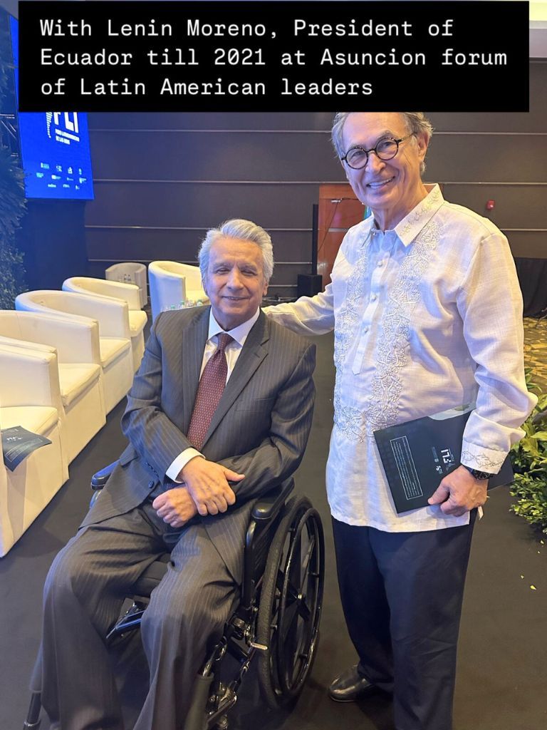 Lenin Moreno, former President of Ecuador, seated in a wheelchair, alongside another participant during the Asunción Forum of Latin American Leaders.