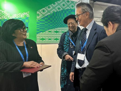 From left to right, the image shows Mrs. Maria Antonia Yulo-Loyzaga, Secretary of Environment of the Philippines, engaging in conversation with Mrs. Cecile Alvarez, UNESCO Artist for Peace, and Viktor Sebek, Chairman of SSCC. They are standing in front of a vibrant, green backdrop during an event at COP 2024.